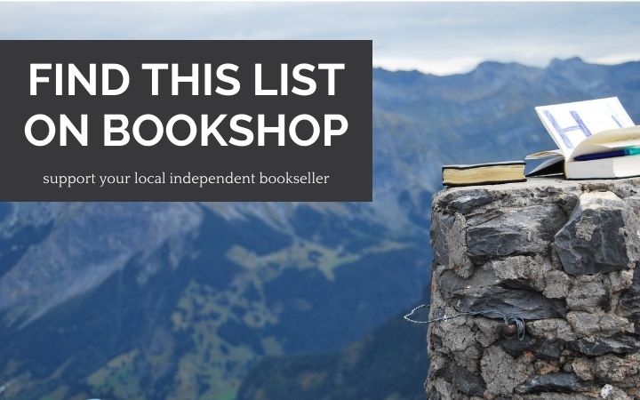 Books on rocky outpost with mountains in background