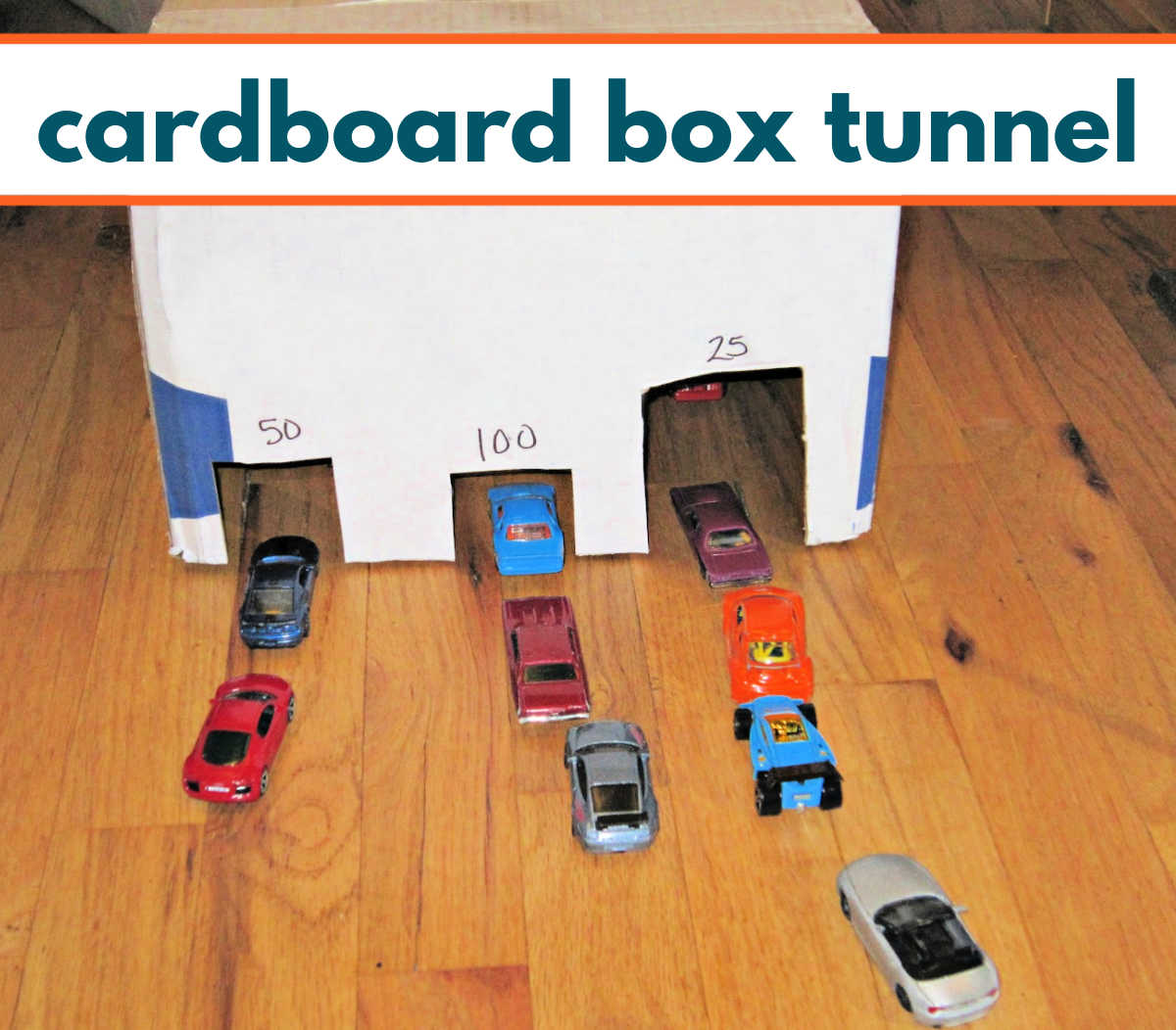 Three entrance tunnel made out of a cardboard box with lines of toy cars waiting to go through. 