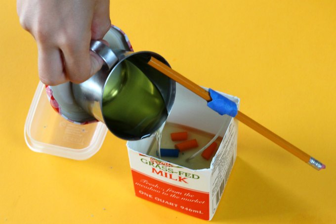 Pouring wax to make milk carton candles.