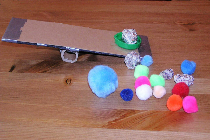 Cardboard diy catapult and pompoms