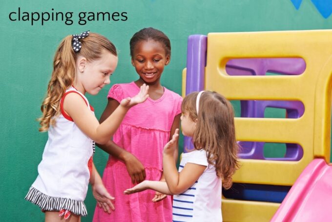 three girls playing a clapping game