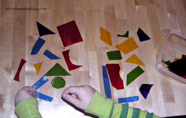 Child making faux easy stained glass abstract art project at table