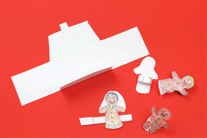 Folded and cut our gingerbread house coloring page and four finger puppets