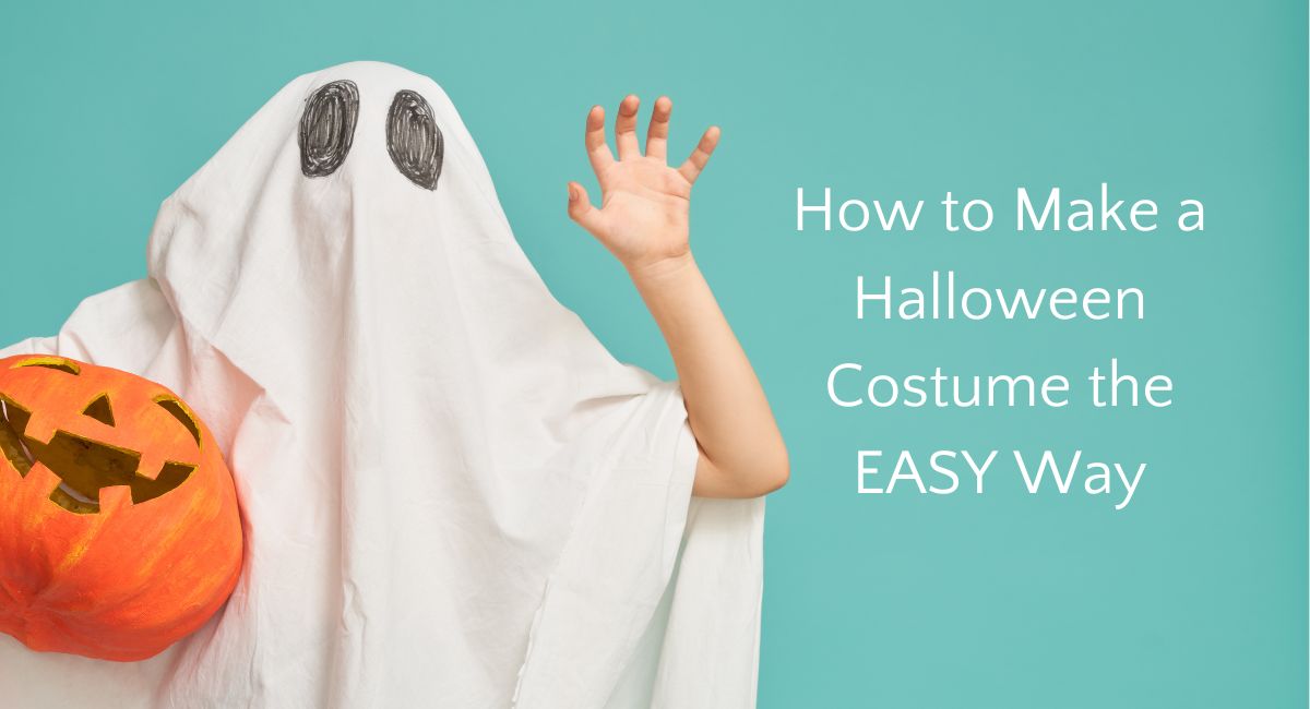 Child in homemade ghost costume holding pumpkin