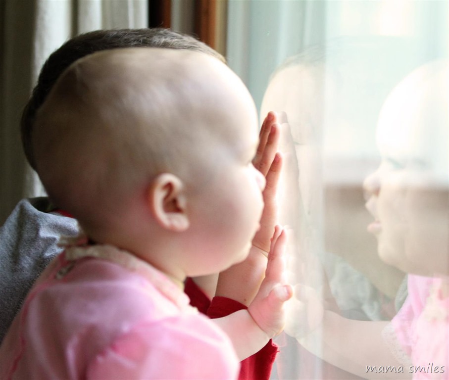 Baby looking out of a window