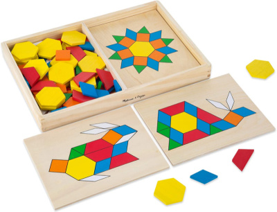 Colorful children's math toy pattern blocks in open box with animal and star design layouts