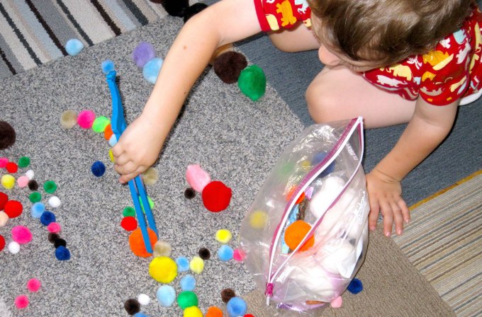 Picking up pom poms with chopsticks