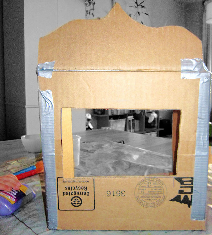 Cardboard puppet theater diy in progress.