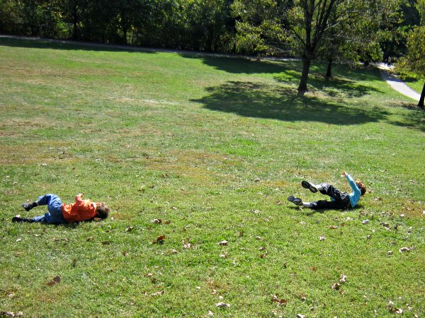 Classic outdoor activity for kids: rolling down the hill.