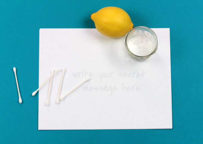 blank paper with q-tips, lemon and jar
