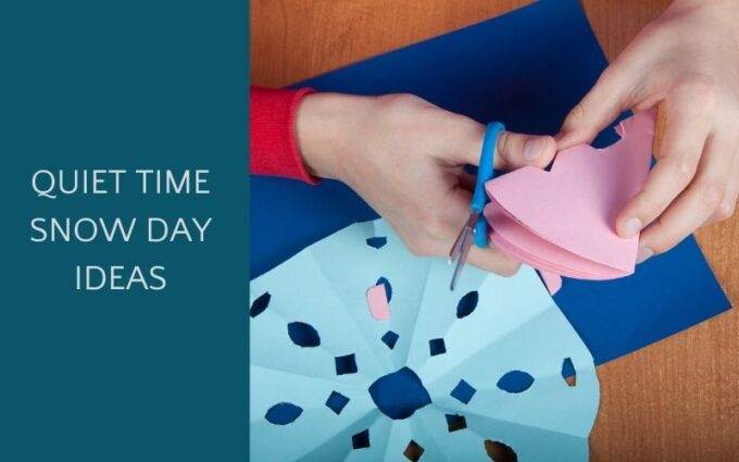 Child cutting paper snowflakes as a snow day activity