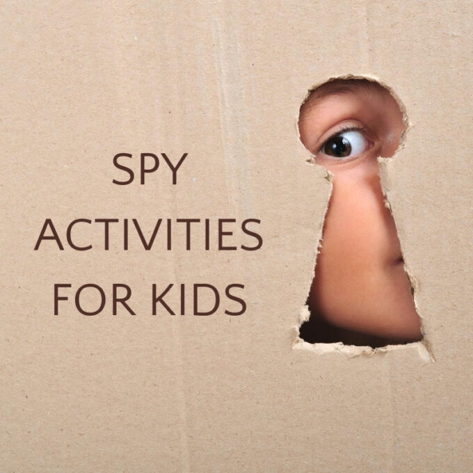 child looking through keyhole in cardboard