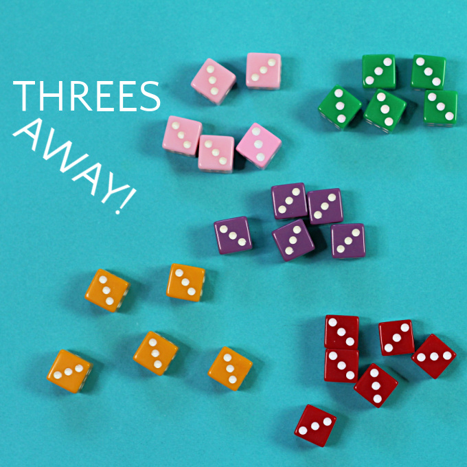 Five sets of colored dice for the game threes away