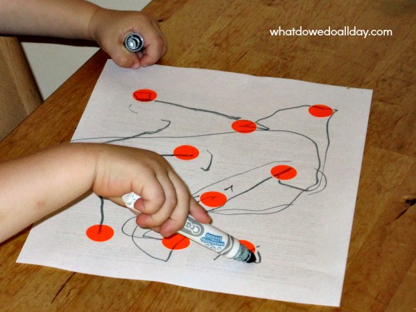 Child marking on toddler dot to dot activity