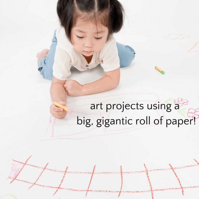 Child drawing on big roll of paper